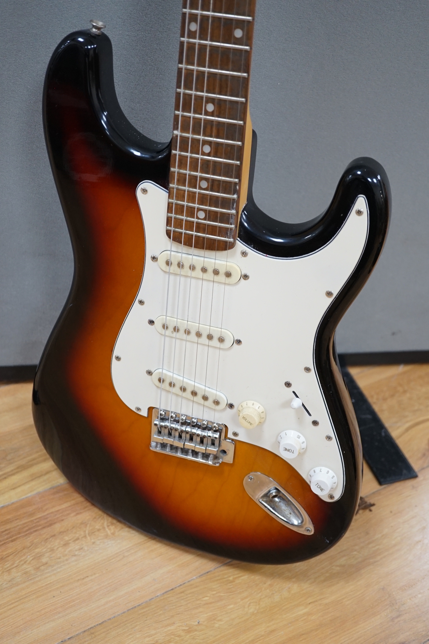 A Collins Sunburst electric guitar with hard flight case